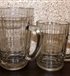 A pair of beer mugs 0.5 liters and 0.25 liters. Side view.
